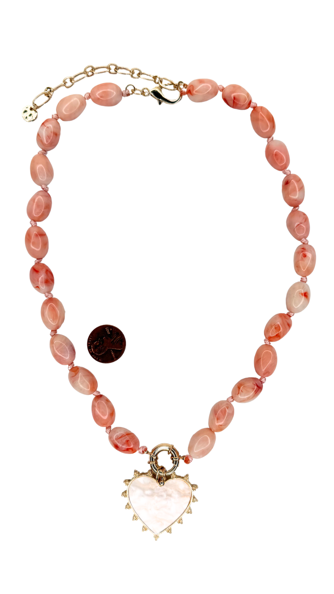 Necklace with pink beads and a heart-shaped pendant on a white background