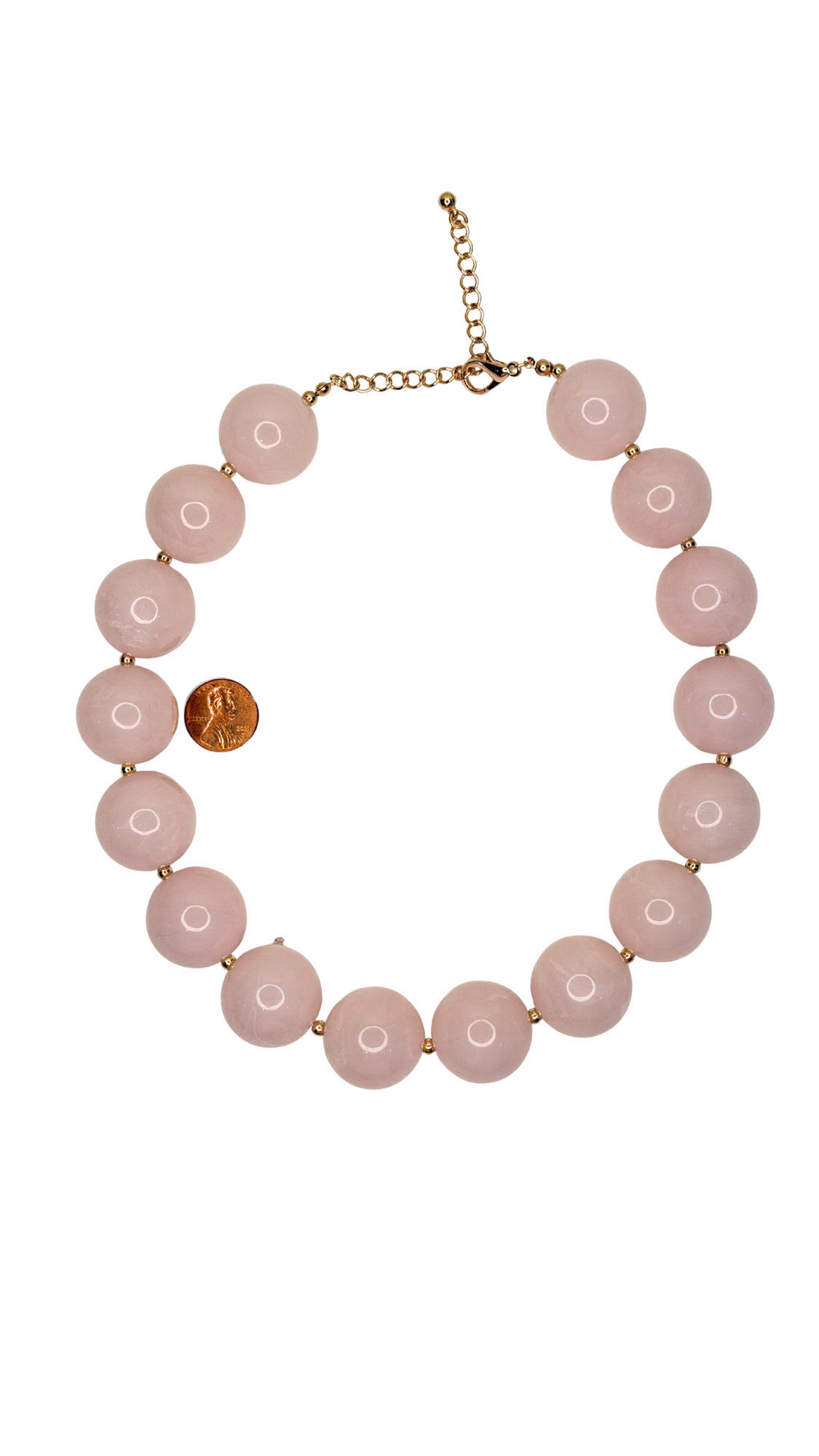 Necklace with pink beads and a gold chain on a white background
