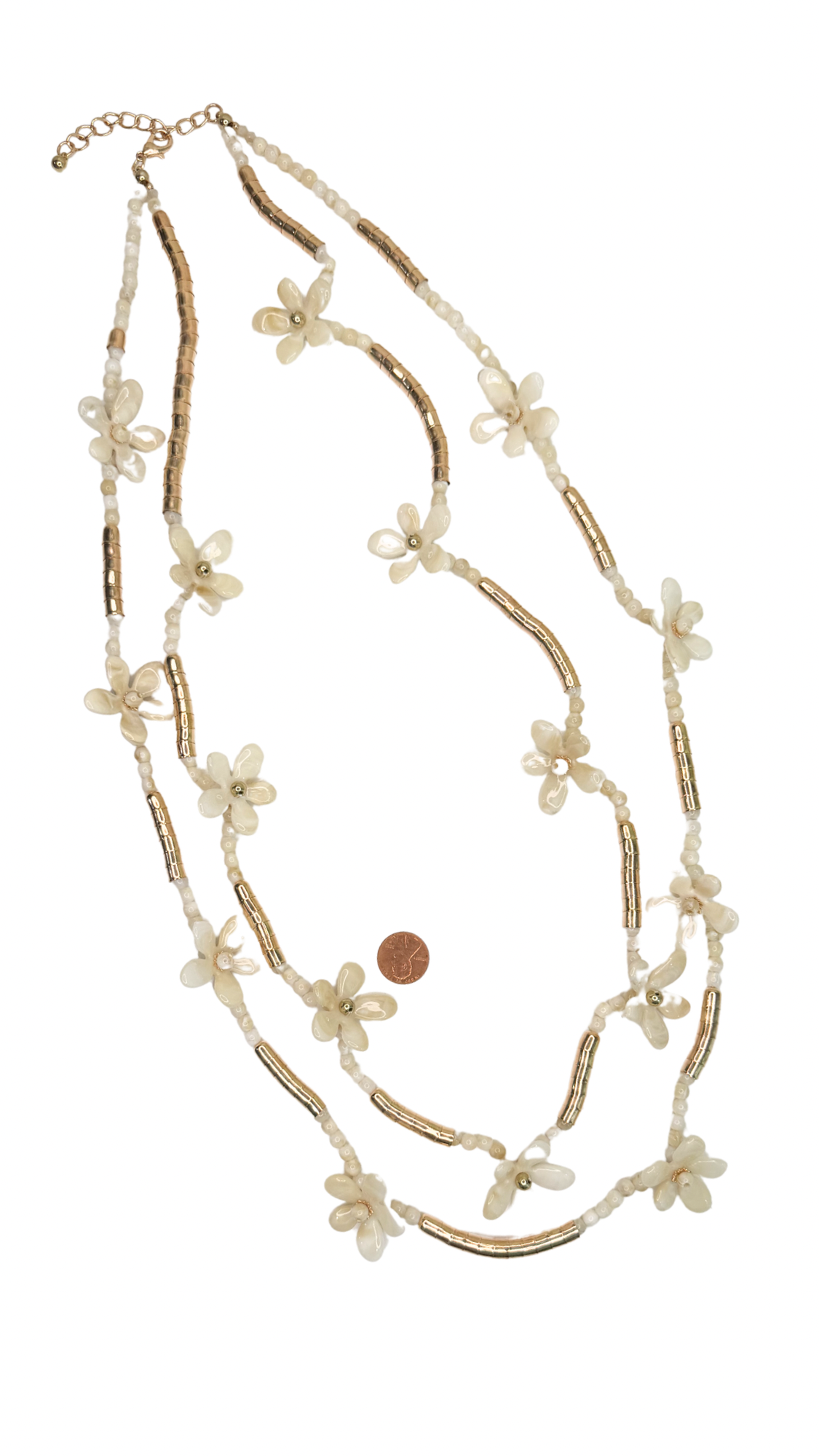 Multistrand necklace with floral and bead details on a white background