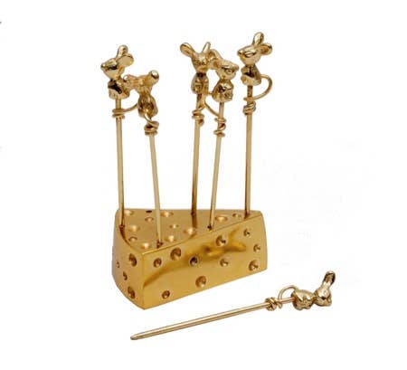 Gold cheese grater with decorative handles on a white background