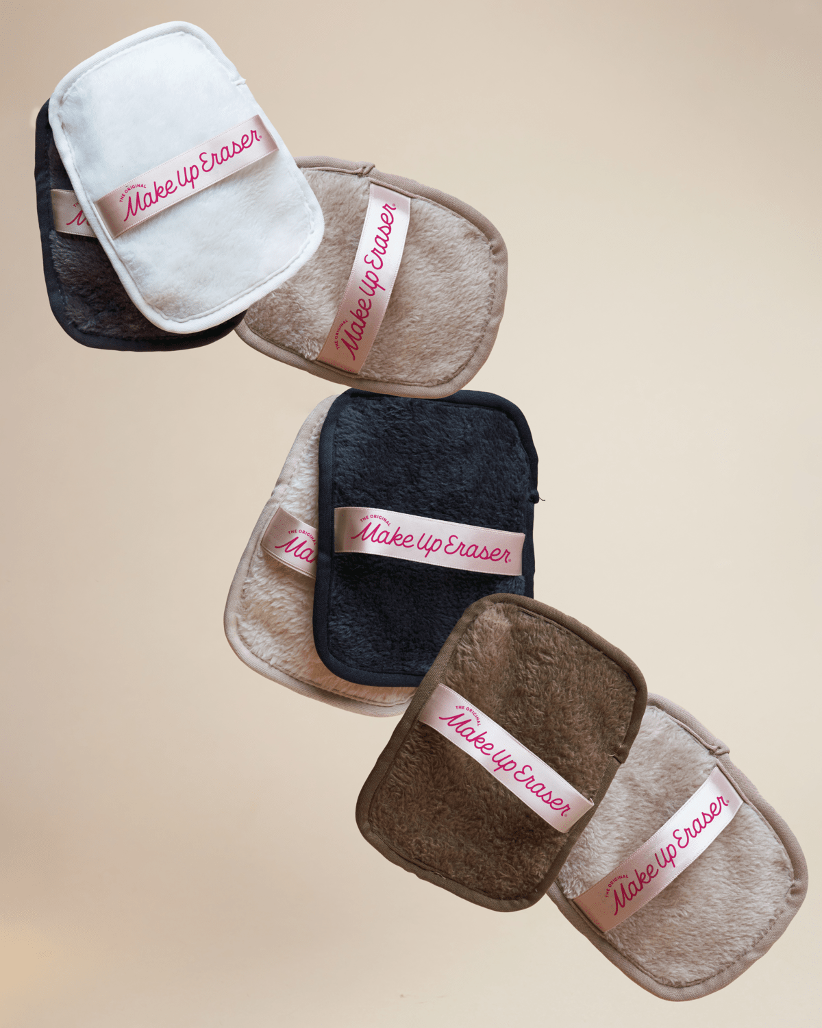 Makeup eraser pads in various colors on a beige background