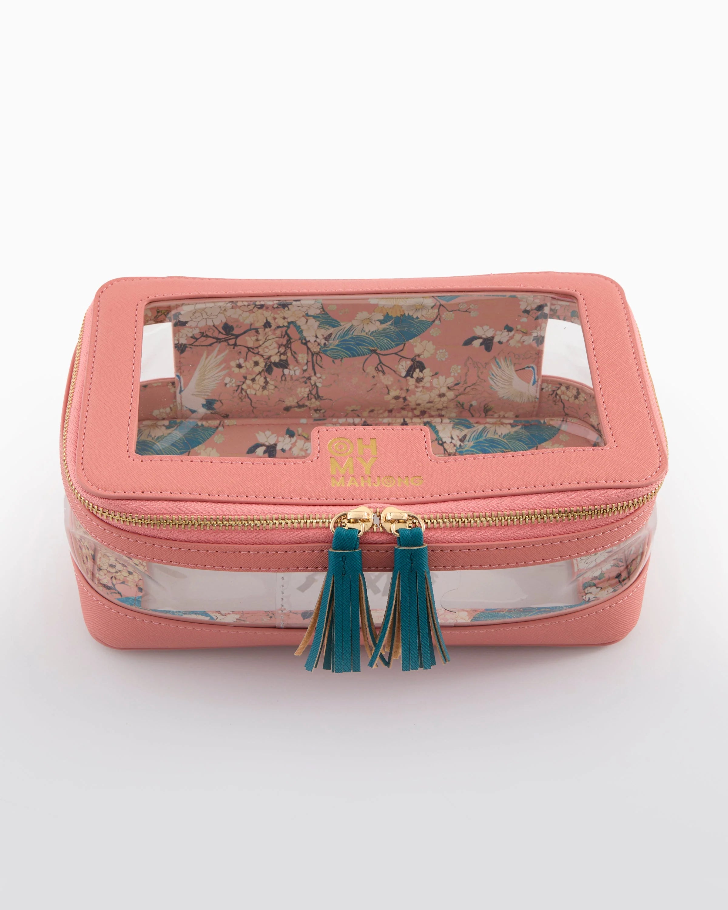 Pink jewelry box with floral design and green tassels on a white background