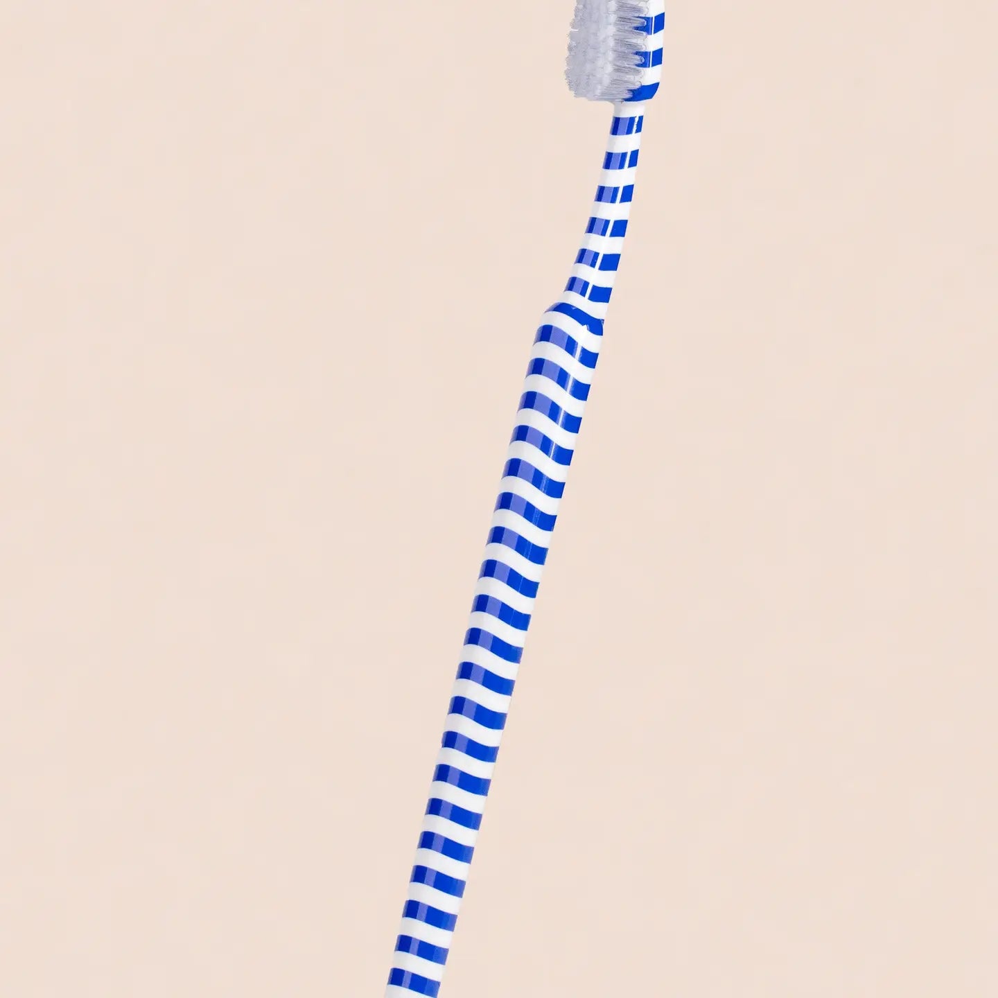Blue striped straw on a beige background
