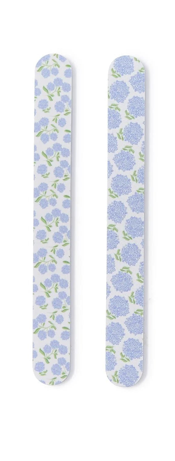 Four floral-patterned nail files on a white background