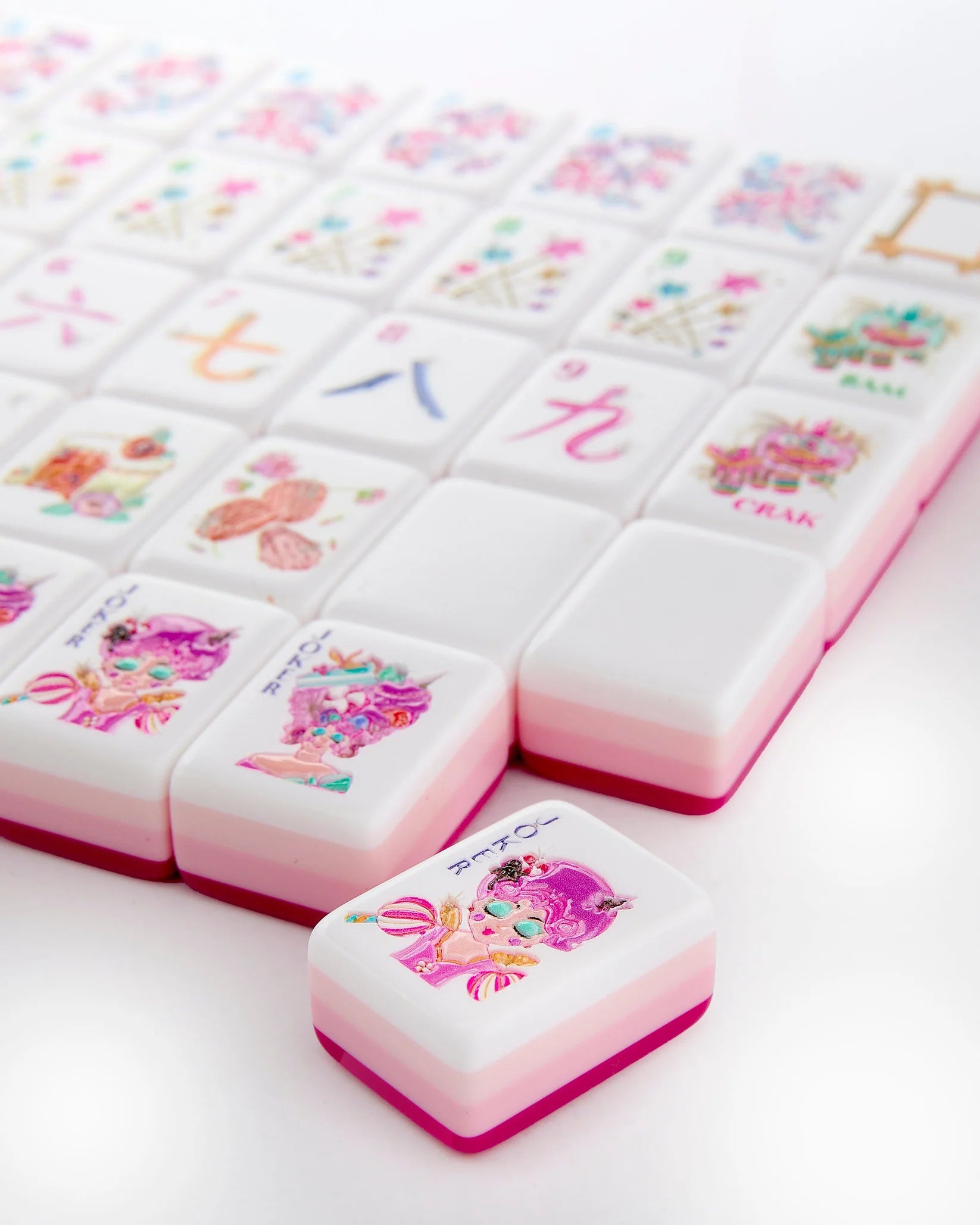Decorative pink and white tiles with cartoon designs on a white background