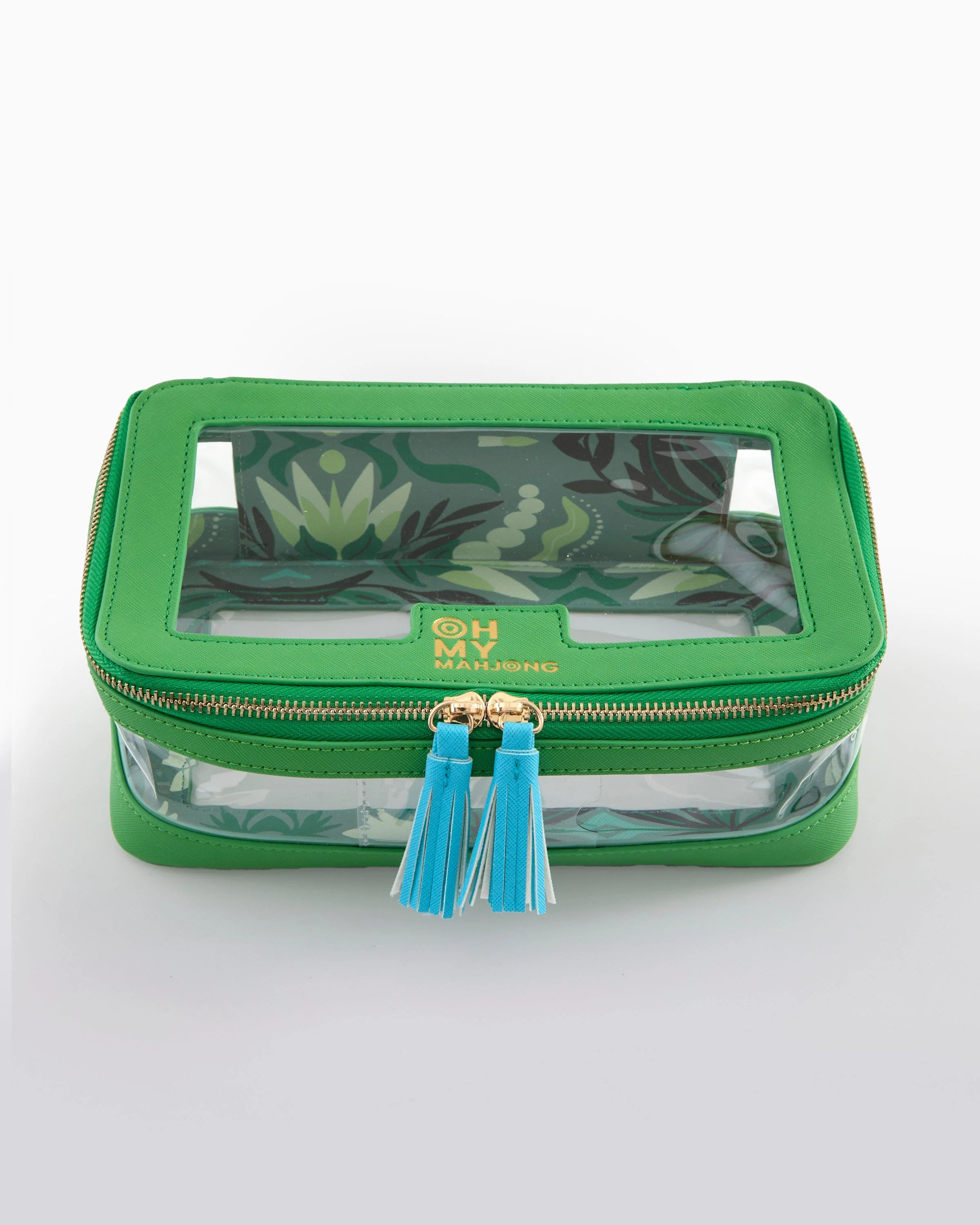 Green cosmetic bag with floral design and blue tassels on a white background