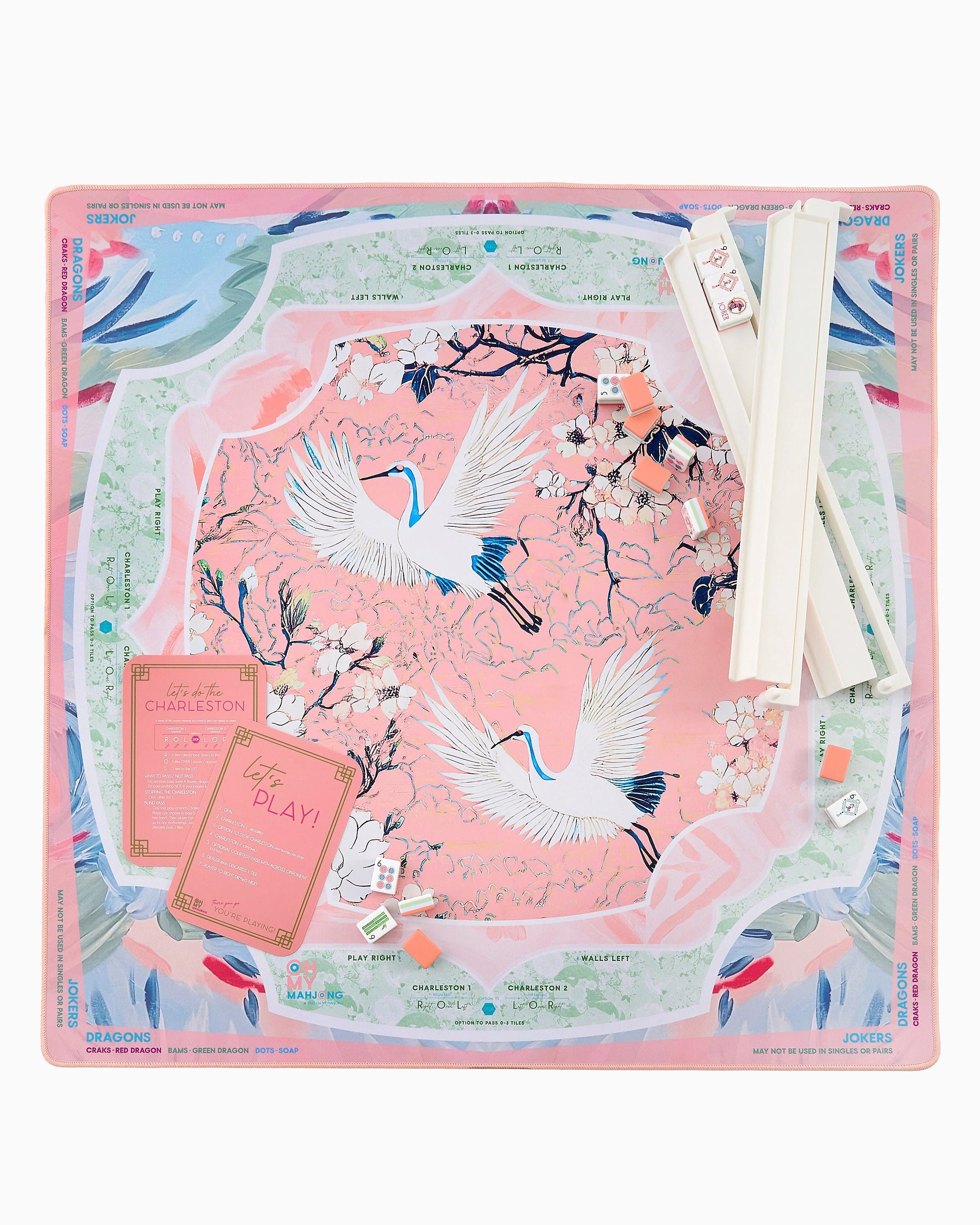 Decorative desk pad with crane design on a pink background
