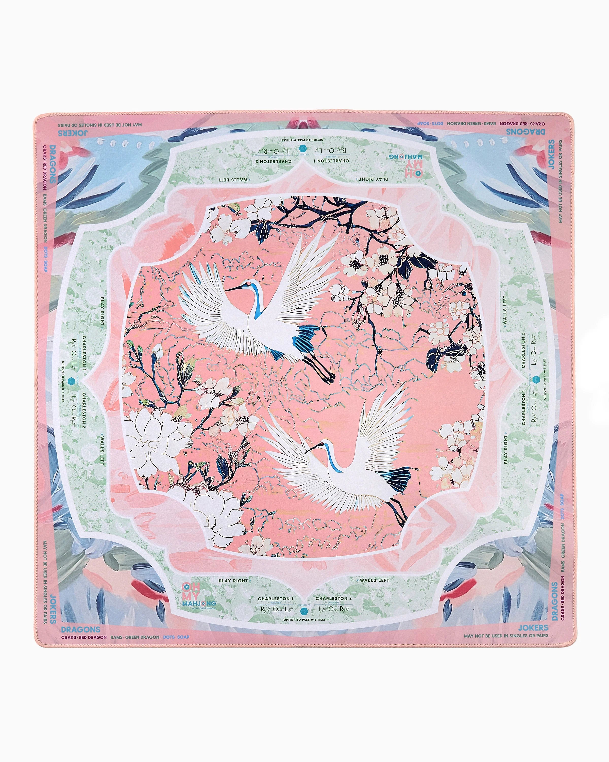 Decorative placemat with cranes and floral design on a pink background