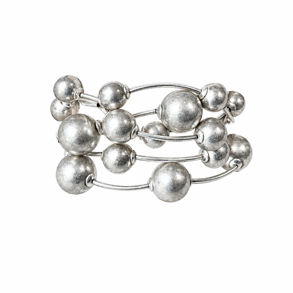 Silver six-strand bracelet alone on solid white, no display pillow