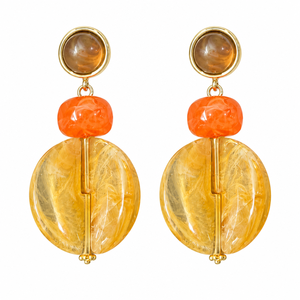 Brown lucite ball statement earrings on white background