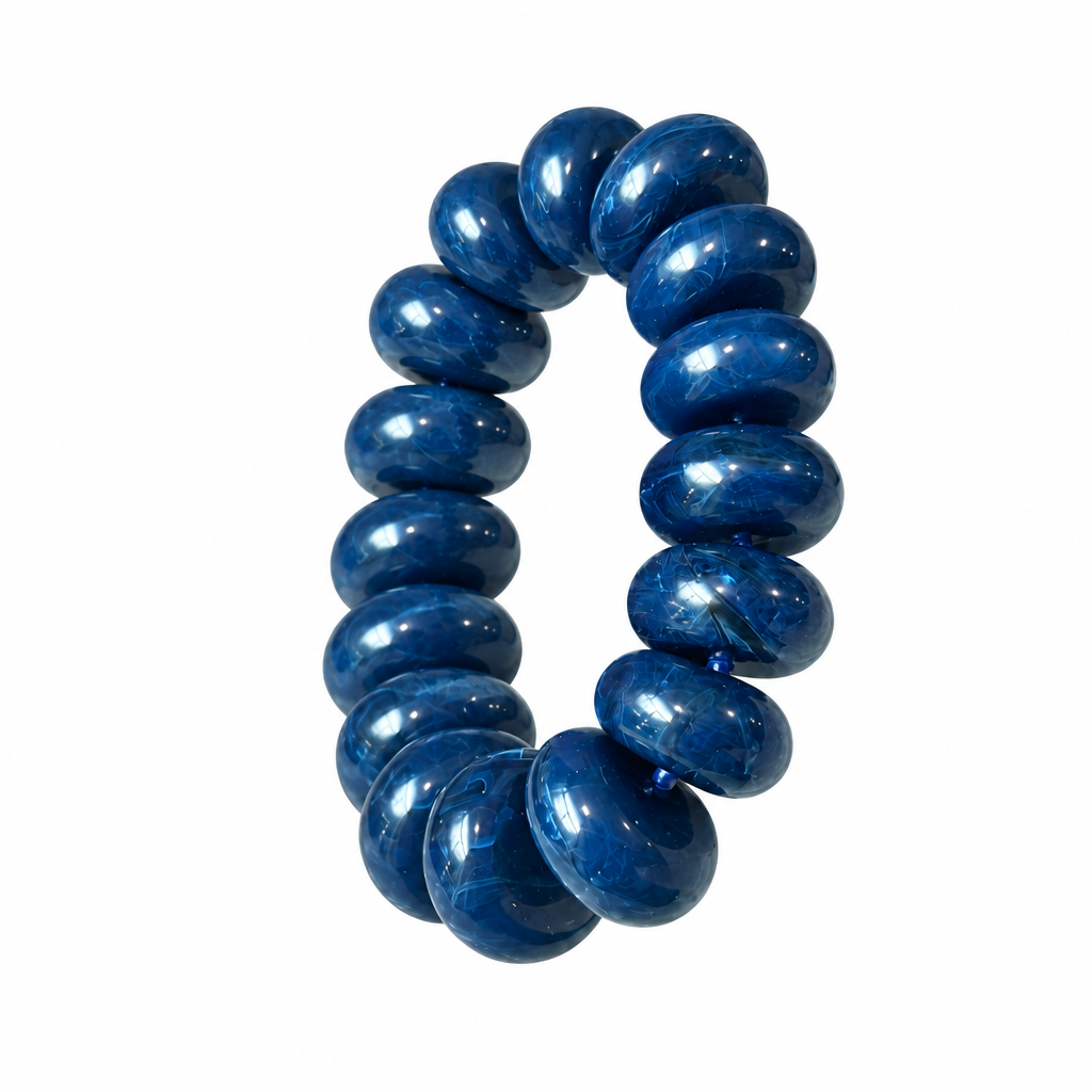 Blue chunky rondelle bead stretch bracelet alone on white background