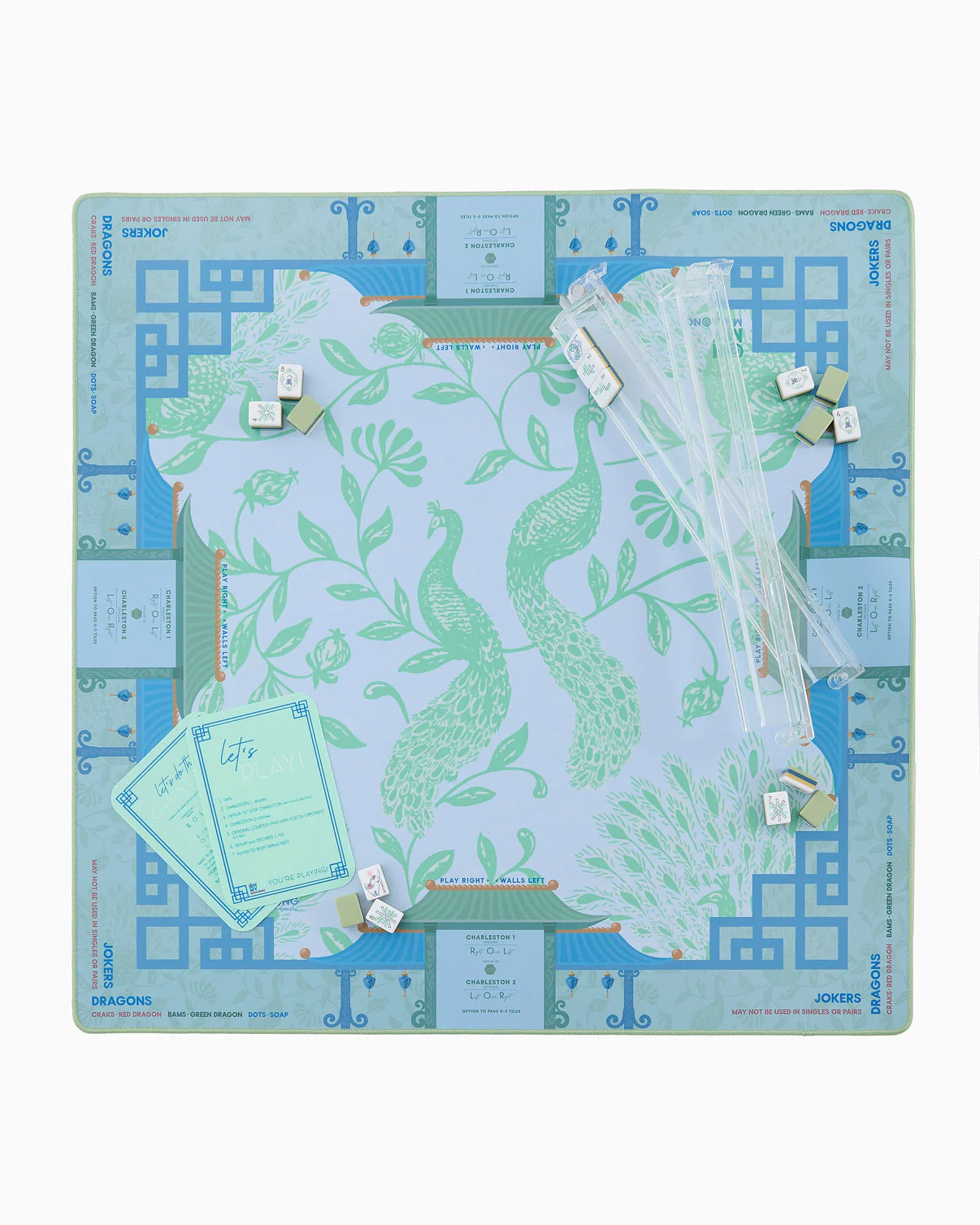 Decorative desk pad with peacock design and accessories on a white background