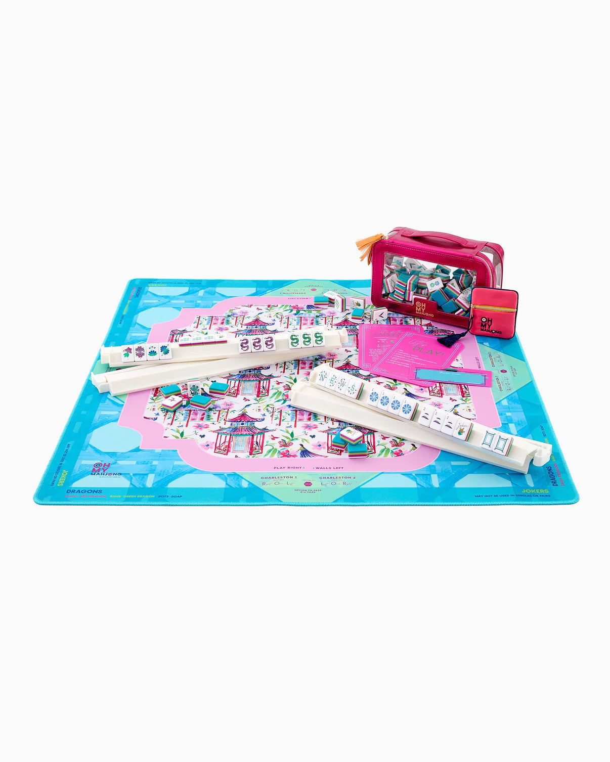 Children's toy set with a colorful mat, remote controls, and a small suitcase on a white background
