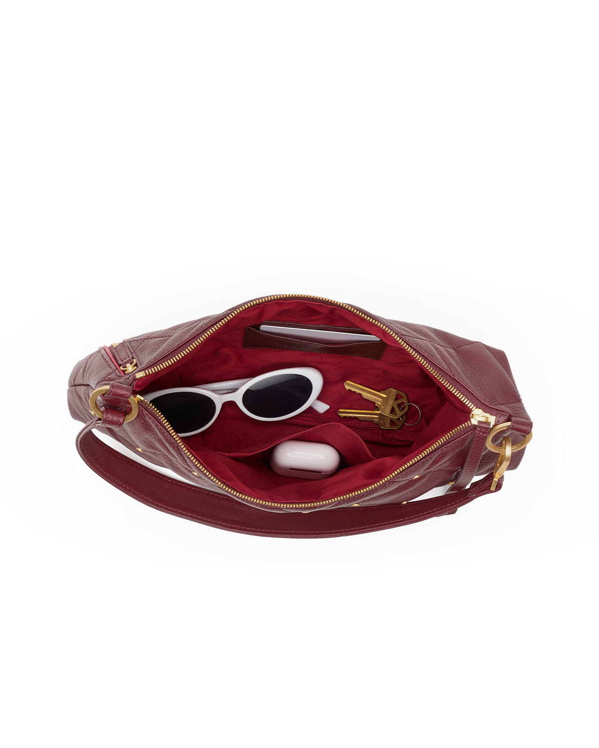 Interior of the cherrywood Kyle bag with sunglasses and accessories inside
