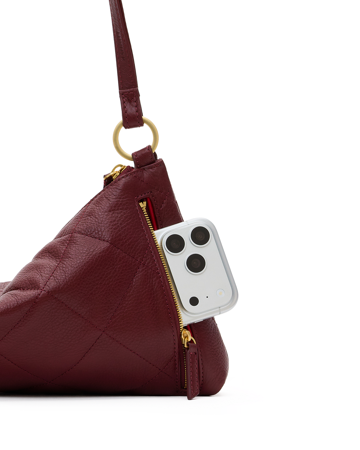 Side view of the cherrywood Kyle quilted bag with brushed gold hardware holding a phone