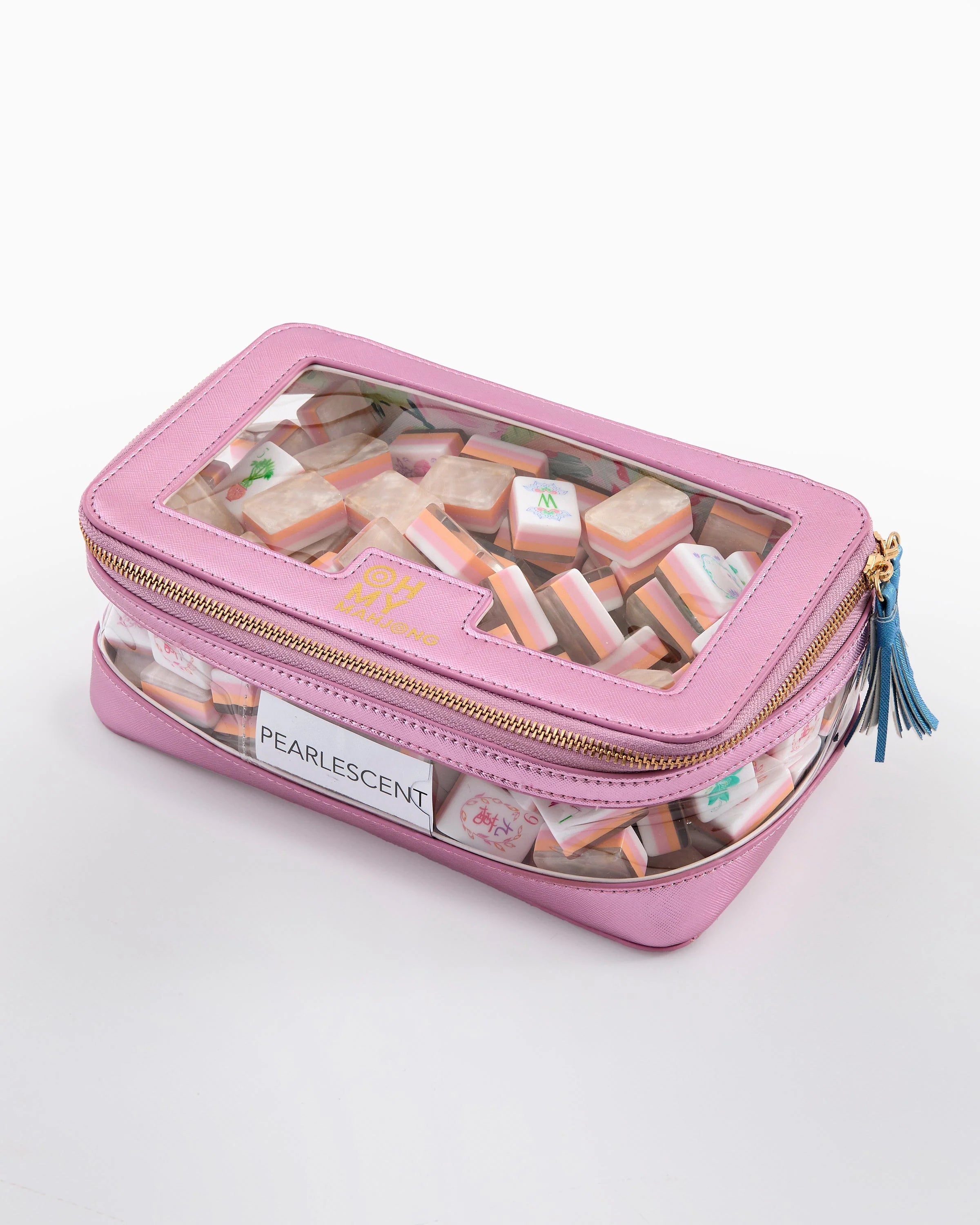 Pink cosmetic case with clear lid containing pastries, on a white background