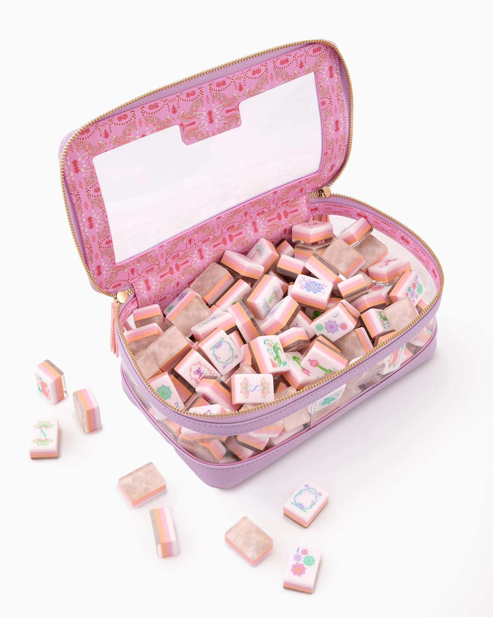 Pink jewelry case with small square items on a white background