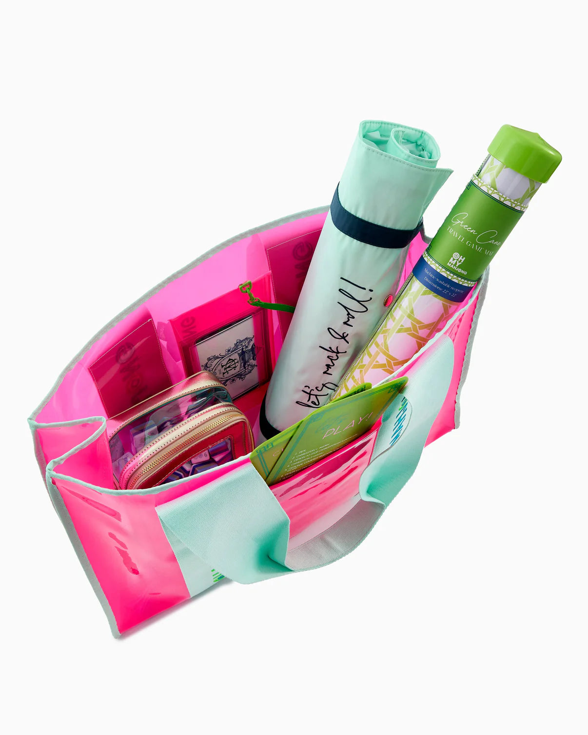 Pink organizer with green and white bottles and a small pink pouch on a white background