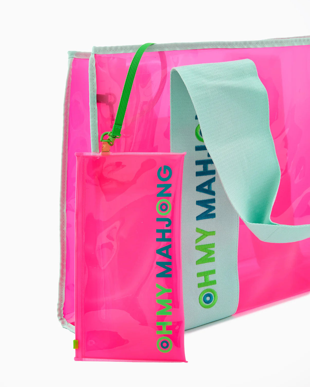 Pink and green Mahjong game set with bag on a white background
