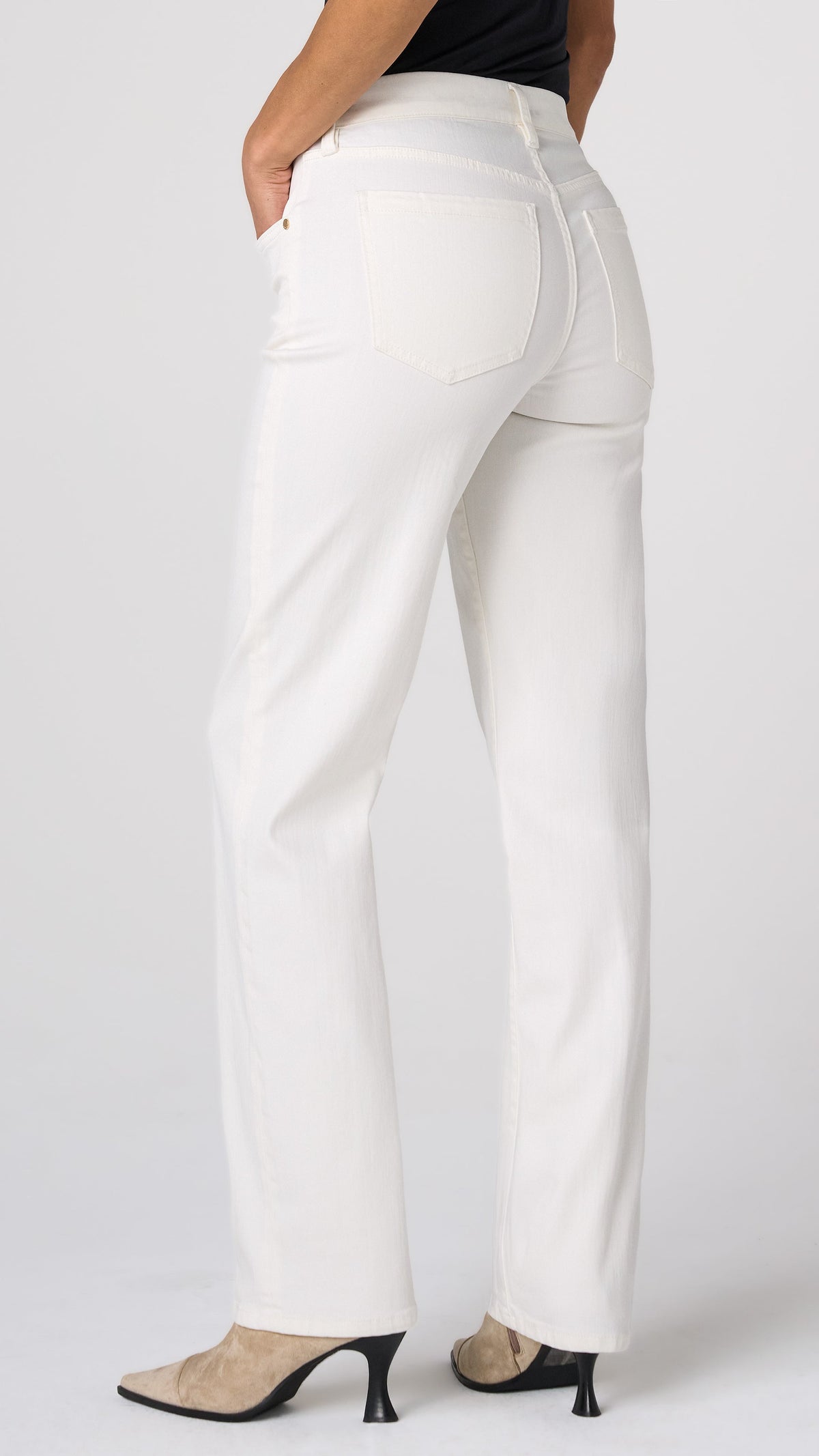 Three-quarter back view of porcelain white Kennedy straight leg jeans with heeled ankle boots