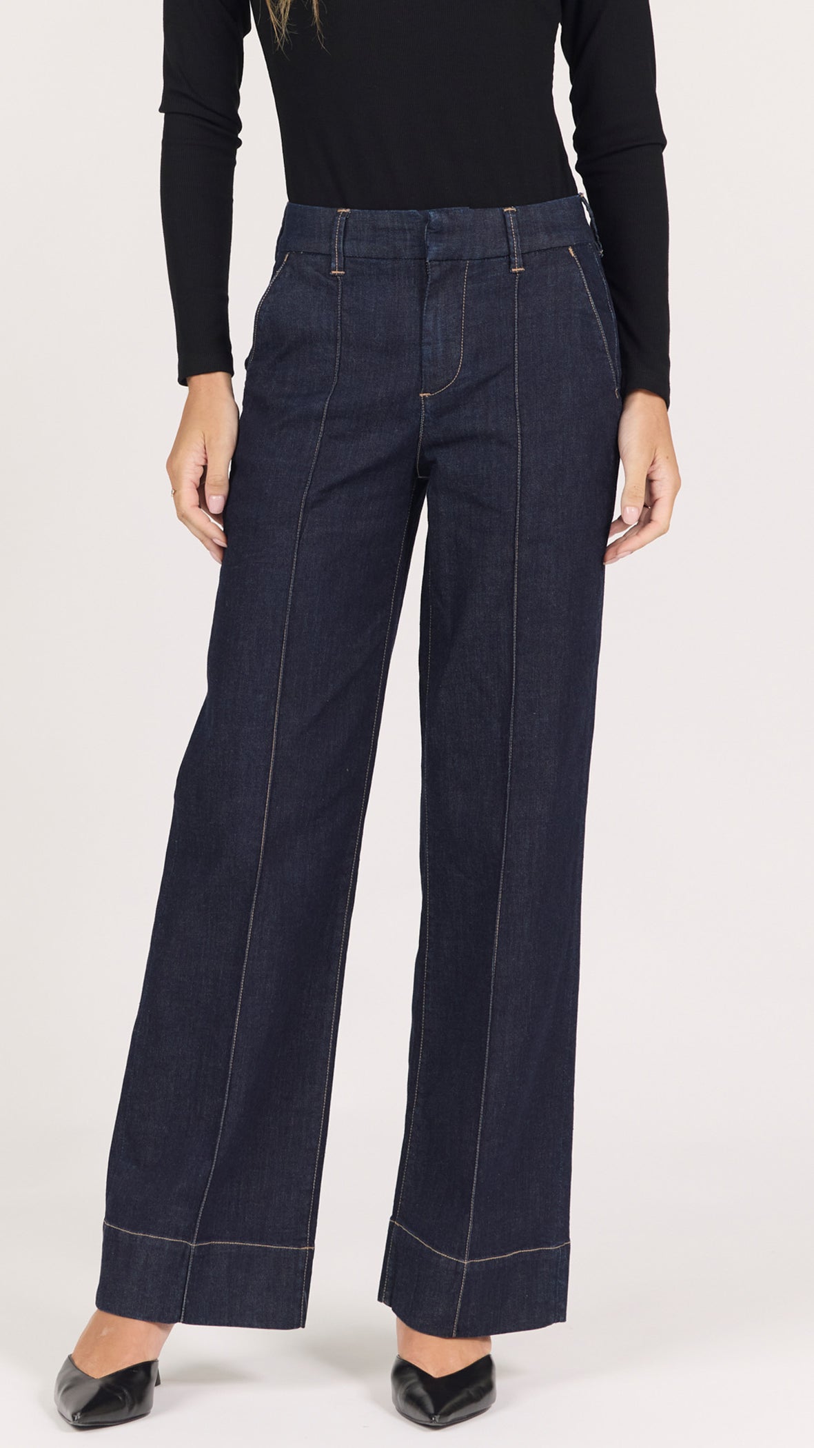 Front view of equinox dark rinse Brandy trousers showing the front seams, contrast topstitching and wide stitched hem