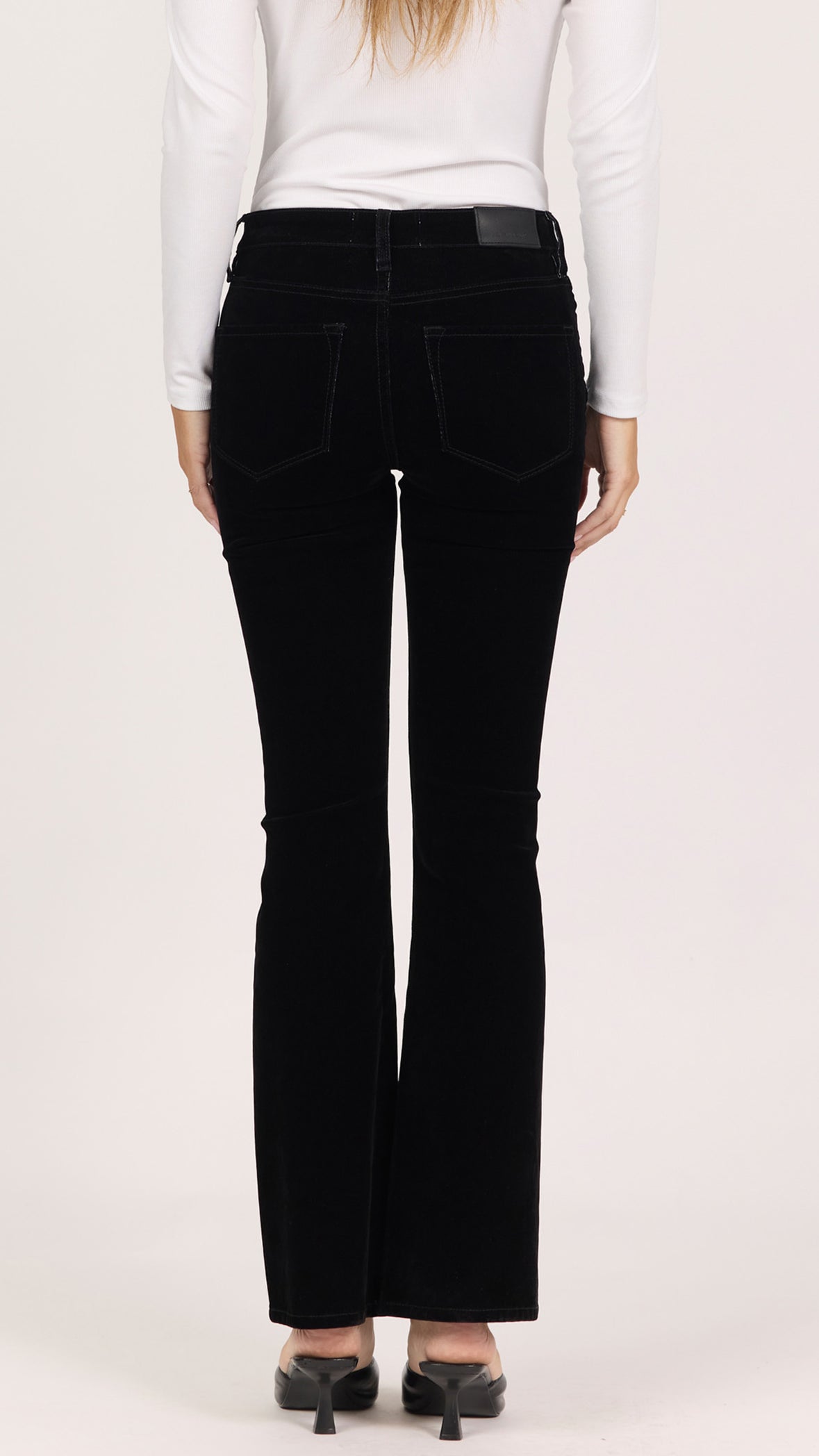 Back view of black dahlia Jaxtyn bootcut pants showing the back pockets