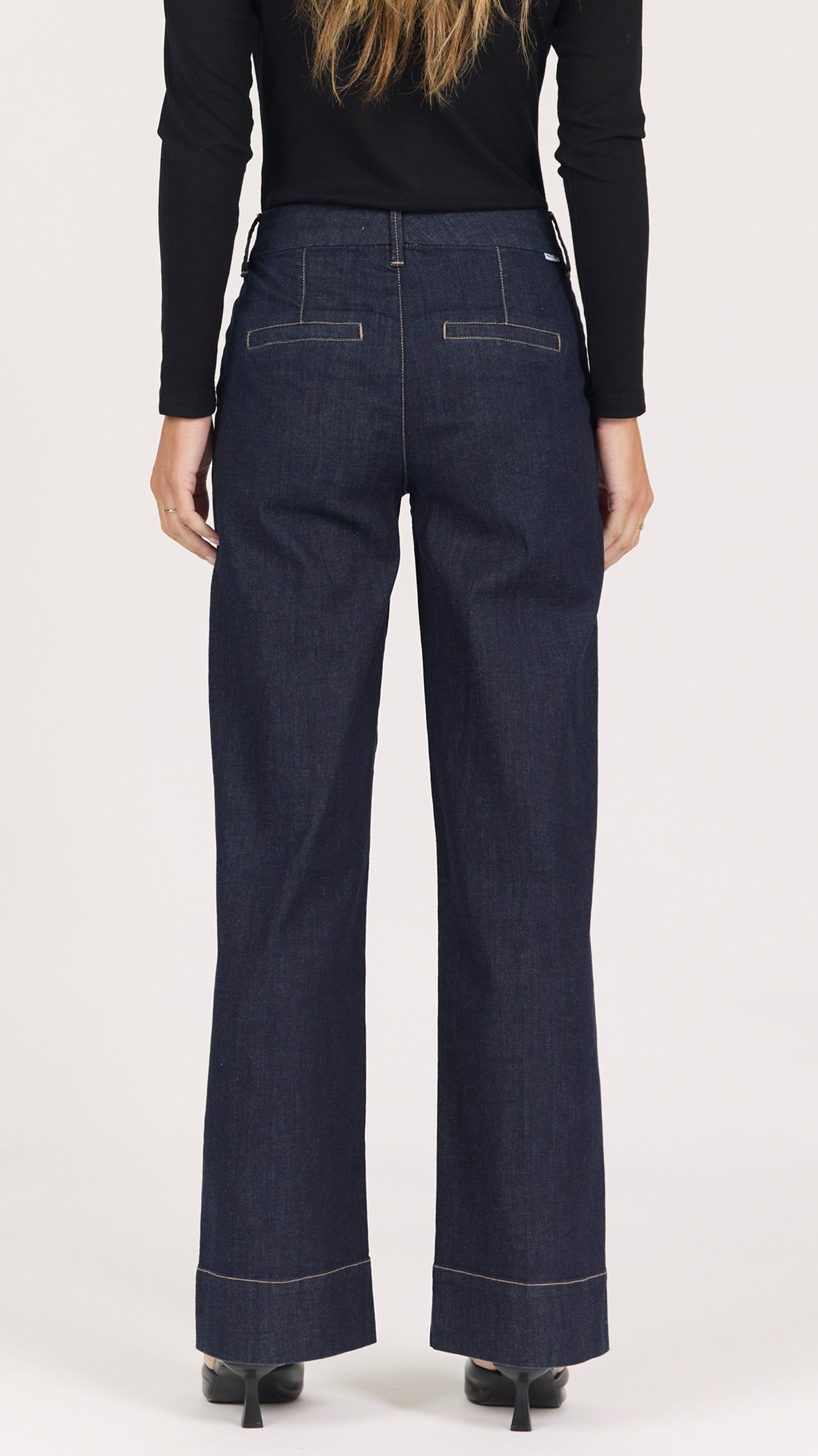 Back view of equinox dark rinse Brandy trousers showing the back pockets and contrast stitching