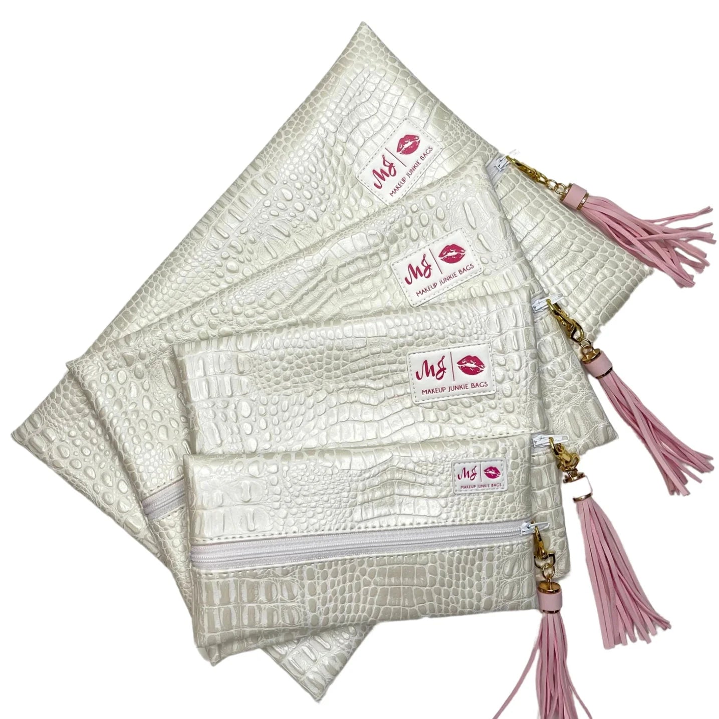 Set of white makeup bags with pink tassels and visible brand logo on a white background