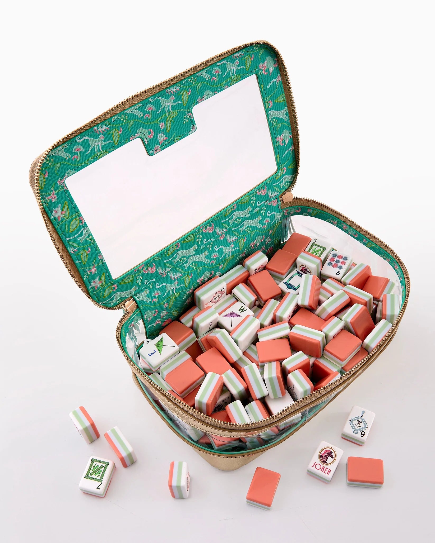 Open green floral-patterned case with red and white tiles on a white background